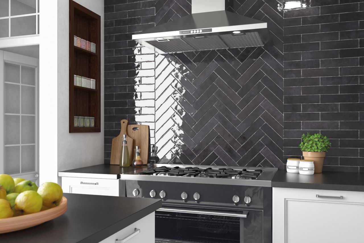 Sleek black elongated subway tile kitchen backsplash installed in a brick-lay and herringbone pattern.