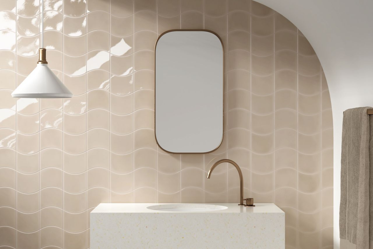 Bathroom wall with cream-colored, cured tile.
