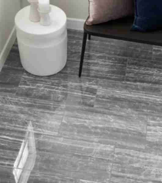 Grey and white limestone-look porcelain tile floor.
