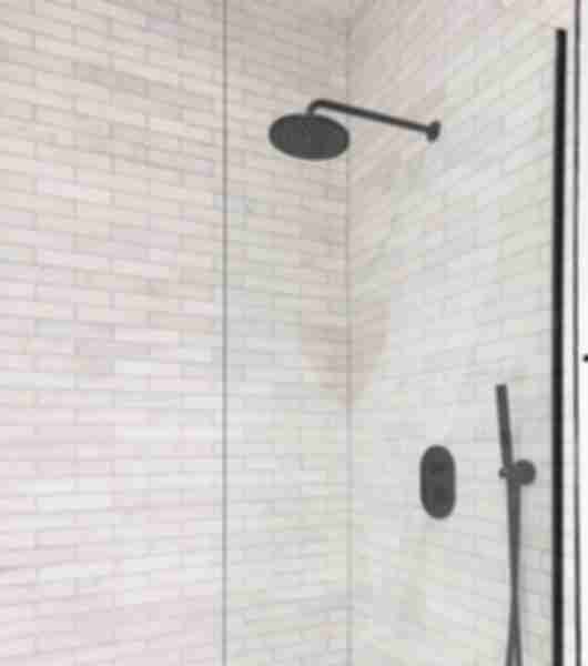 Shower with white marble subway tile.