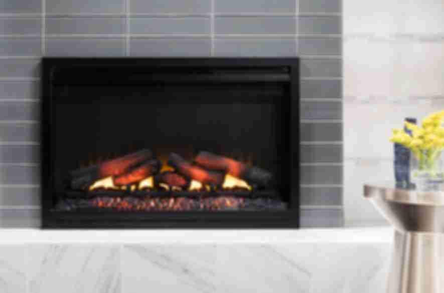 wood burning stove surrounded with grey and marble tiles.