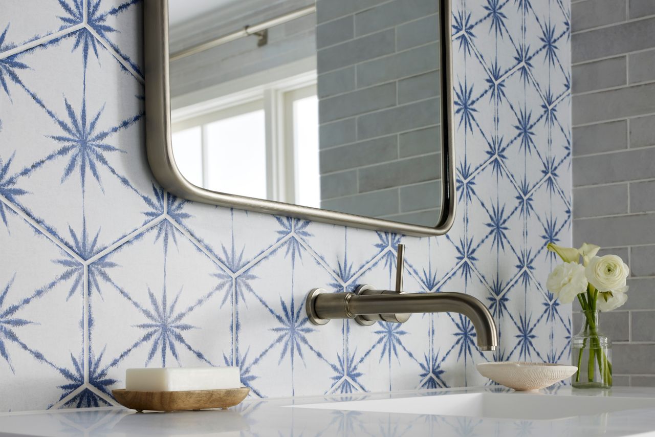 This coastal chic bathroom features a white and blue patterned hexagon-shaped tile wall.
