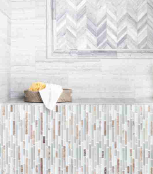 Marble and mosaic wall with a small basket on a shelf.