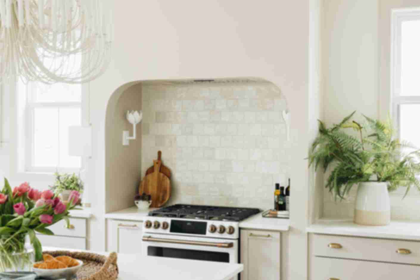 Bright kitchen with white square handmade-look tiled backsplash.