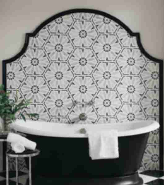 Black and white mosaic wall tile with tub and black and white checkerboard floor.