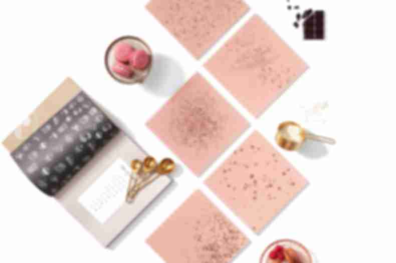 Blush pink glass tile with gold speckles.