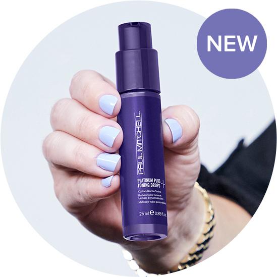 Image of a hand holding our new Paul Mitchell Platinum Plus Toning Drops overlaid with a badge that reads 'NEW'