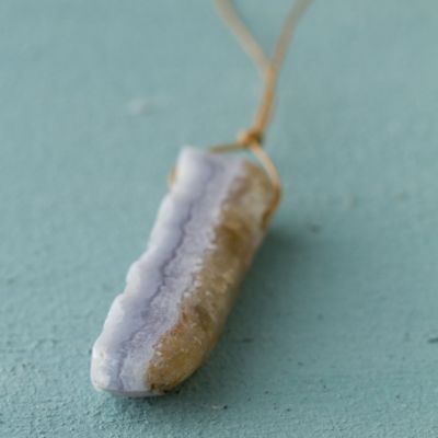 gemstone necklace on blue background