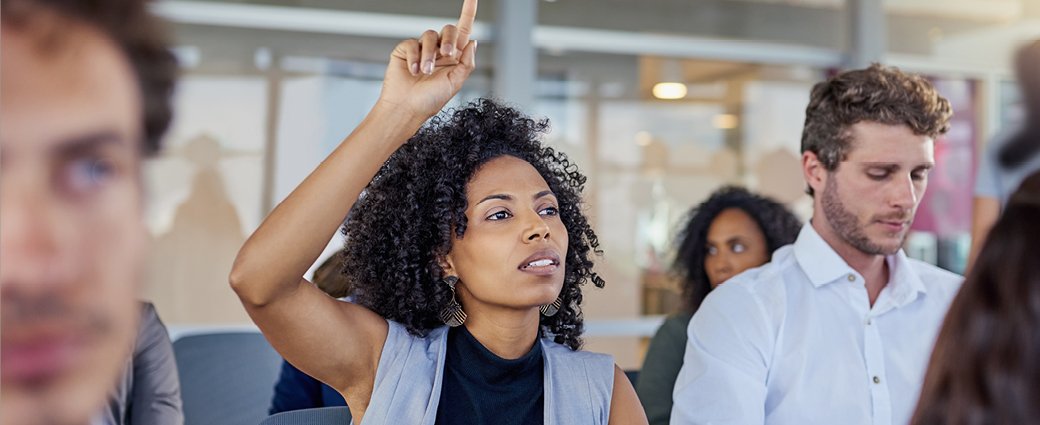 A cheerful young couple, a man and a woman, radiating happiness in a professional setting.