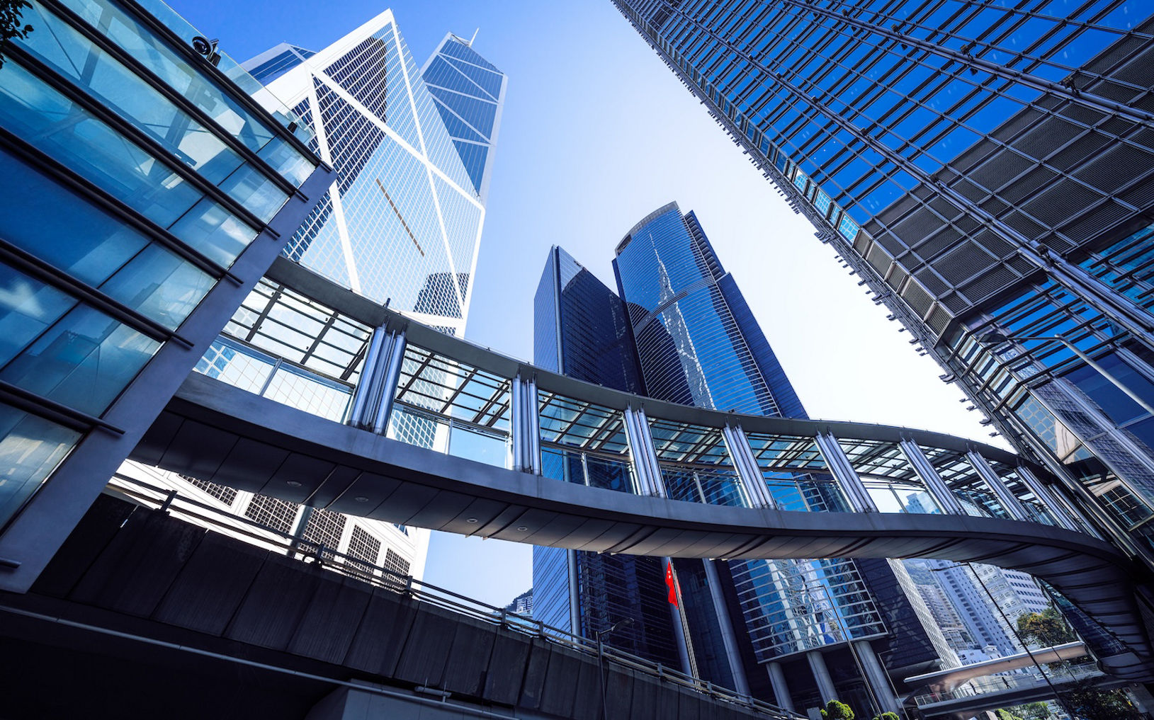 Footbridge and Modern office buildings in central Hong Kong against blue Sky
