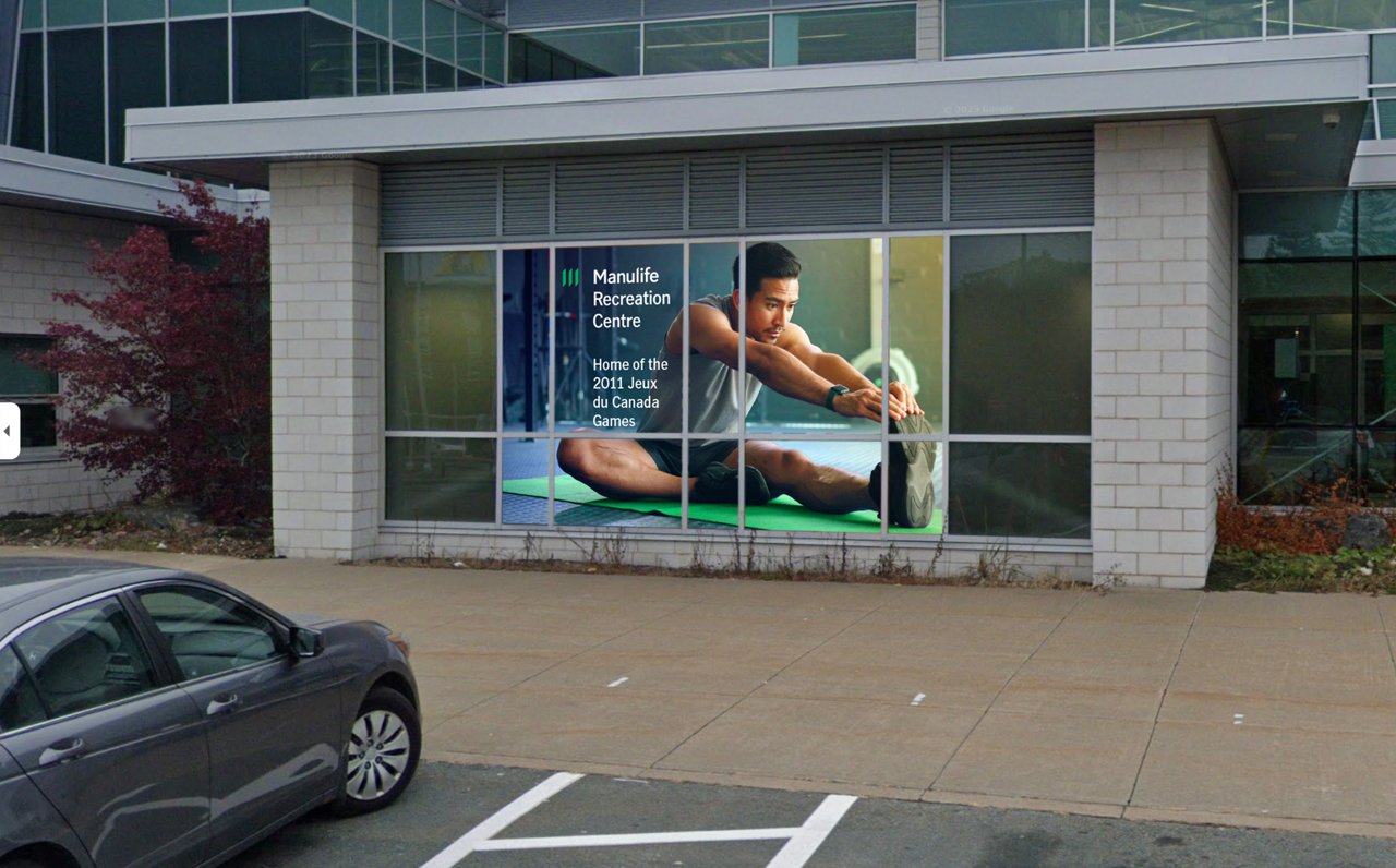 man stretching on window of field house