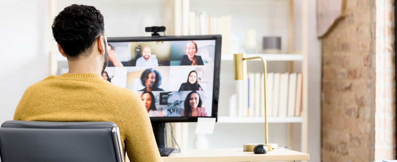 A young businesswoman is imparting valuable business education to a diverse group of men and women.