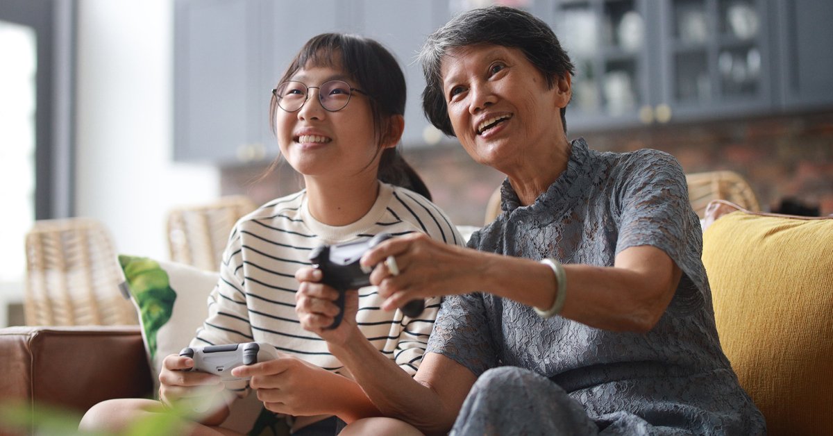 A young, happy couple expressing their love for each other while sitting comfortably at home.