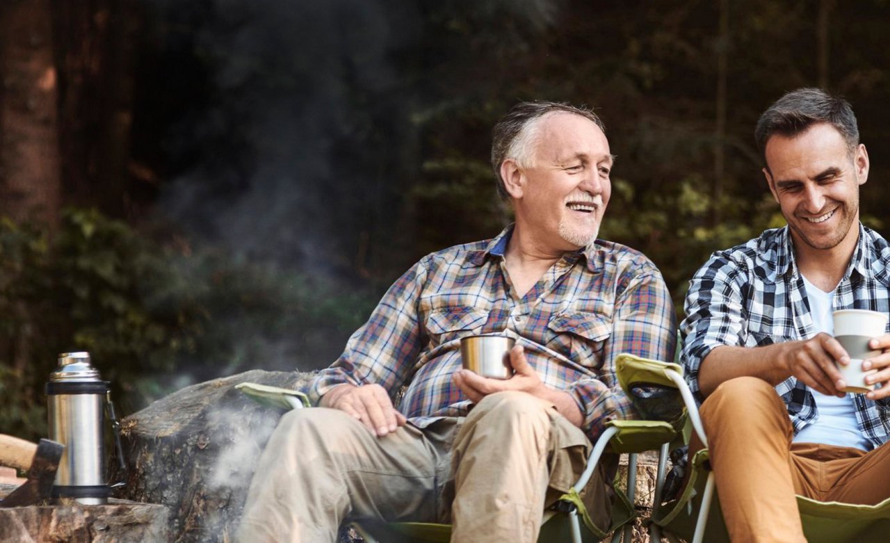 Two fishermen camping in forest