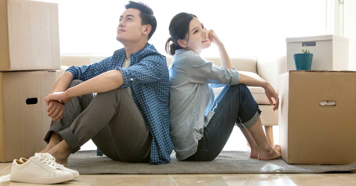 A happy couple, a man and a woman, radiating love and contentment, enjoy their time sitting together at home.