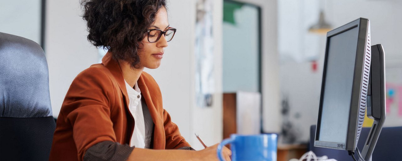 A young woman working at her desk in her office 