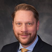 This is a professional head shot image of Alex Grassino.