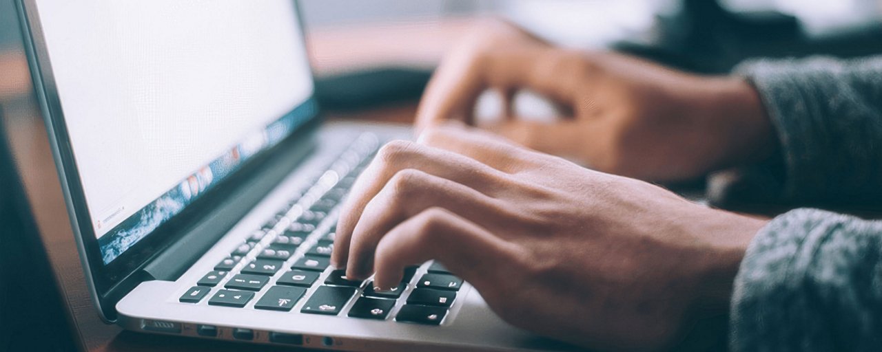 Close up of hands typing on a keyboard on a laptop computer