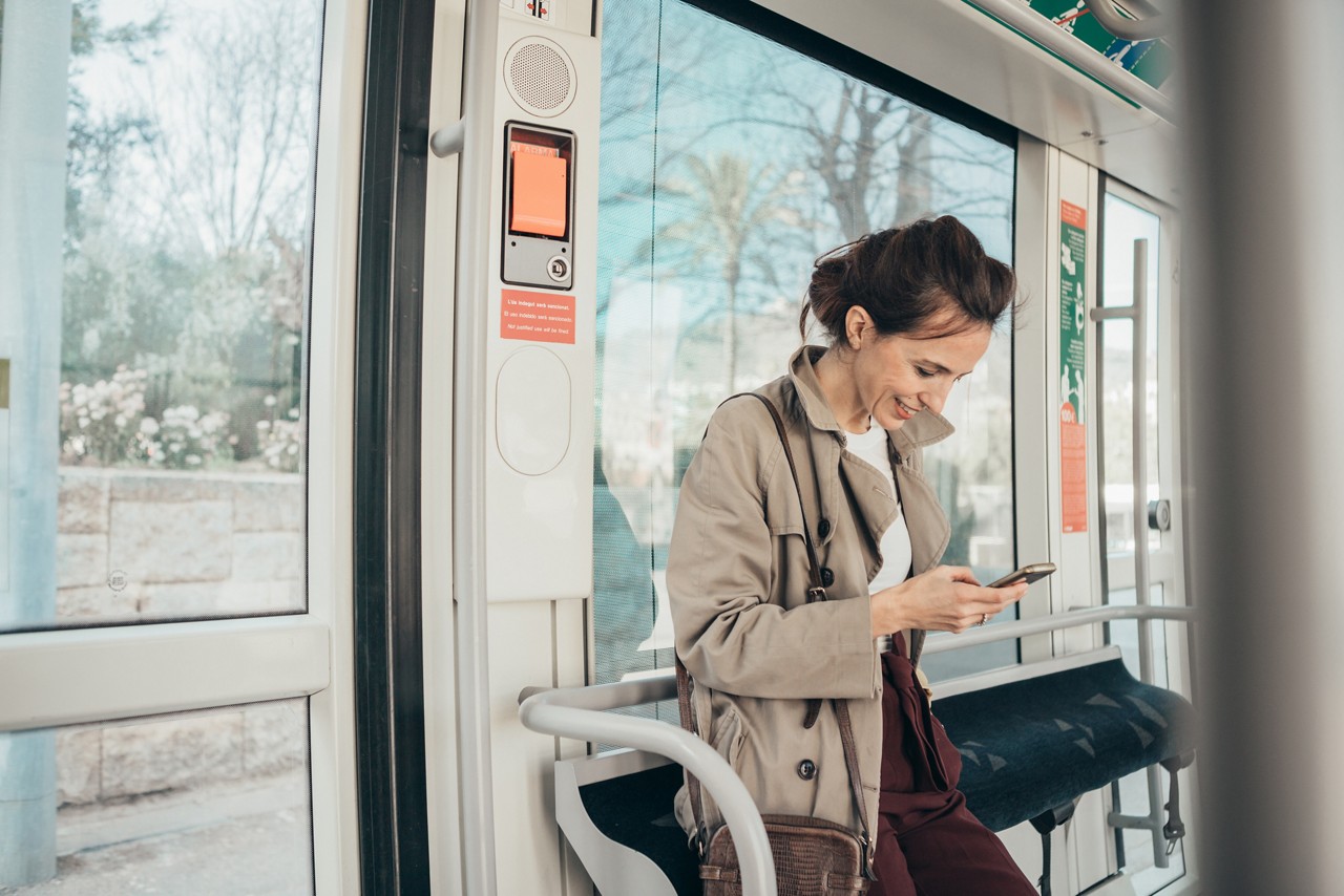 Woman talking on the cell phone at tram