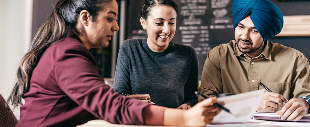 A young, happy couple is engaged in a business education session, furthering their professional adult learning.