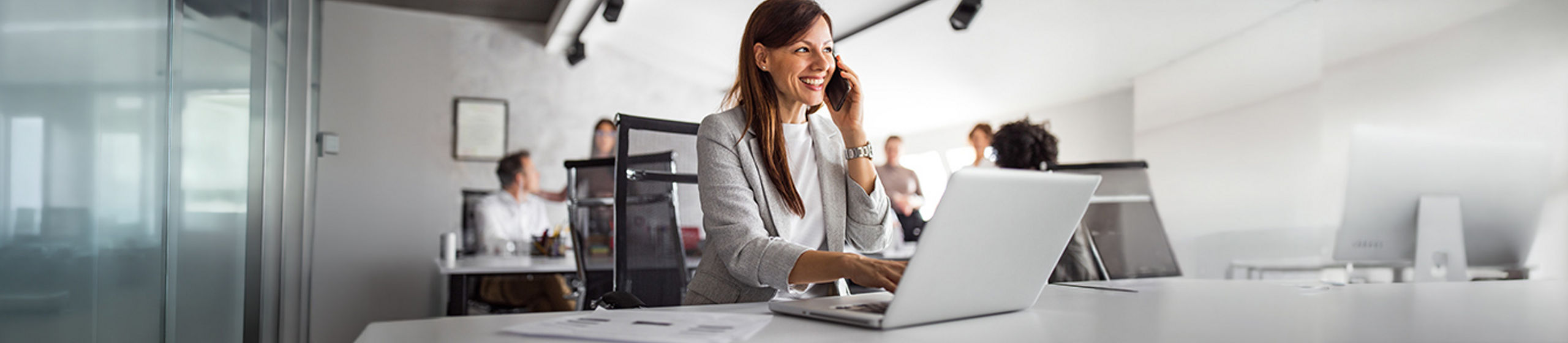 Businesswoman working on laptop in modern office