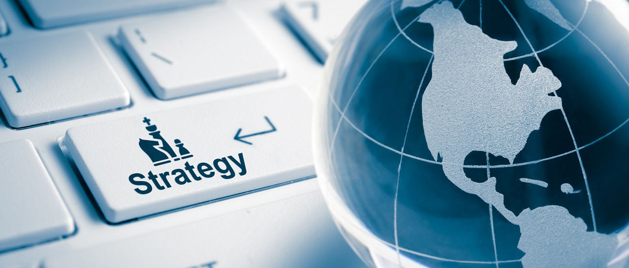 Glass Globe and Strategy text enter key on keyboard , business concept