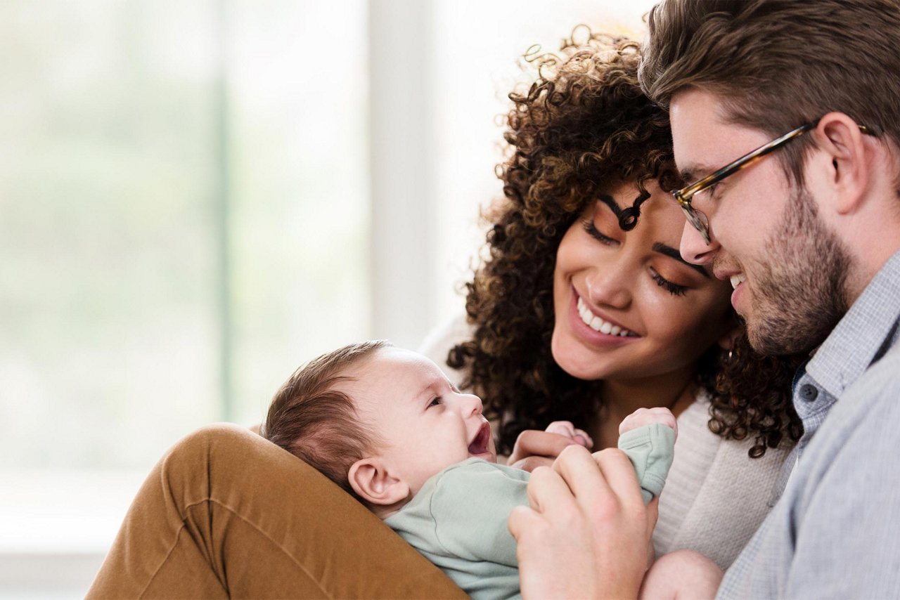 A couple and their smiling baby