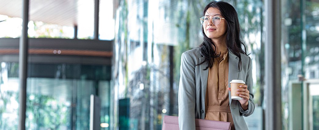 A young businesswoman confidently navigates her professional duties within a contemporary office setting.