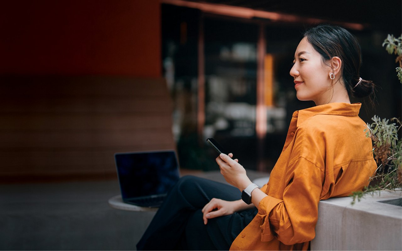 Happy woman using her cellphone.