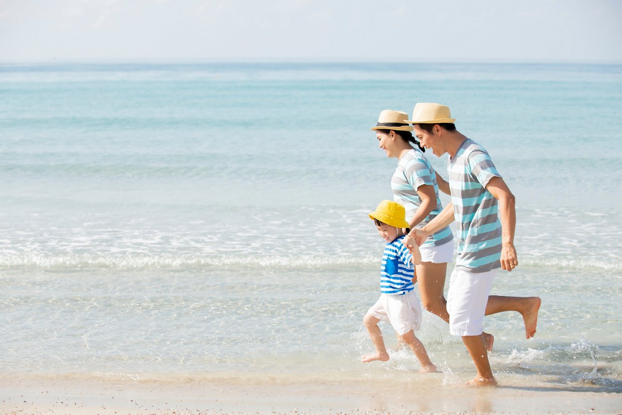 Family having fun on the beach in their best summer ever