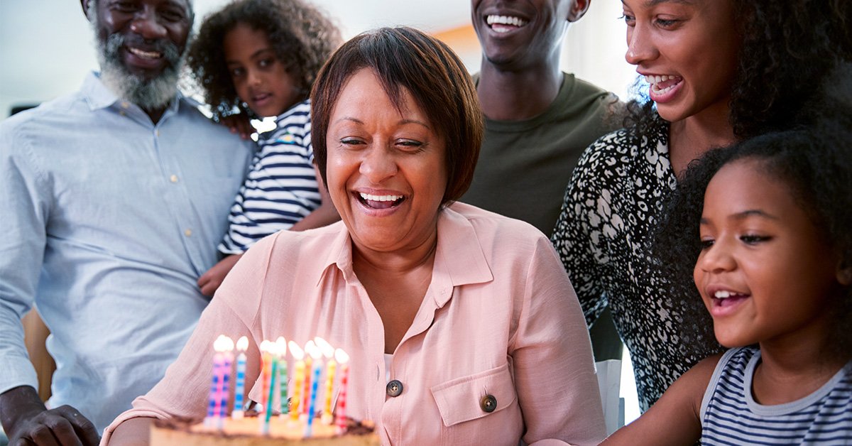 A cheerful couple enjoys a delightful meal at a restaurant, surrounded by smiling friends.