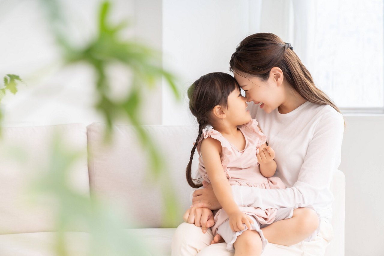 Mother and daughter sitting on a sofa