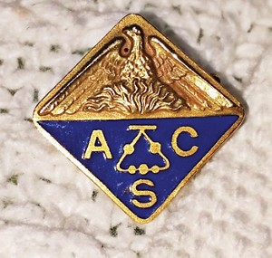 A gold and blue pin with the ACS logo on it.