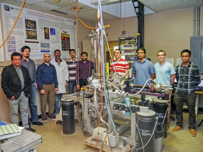 A photograph shows the entire Ohio University nanocar team posing with the group’s STM.