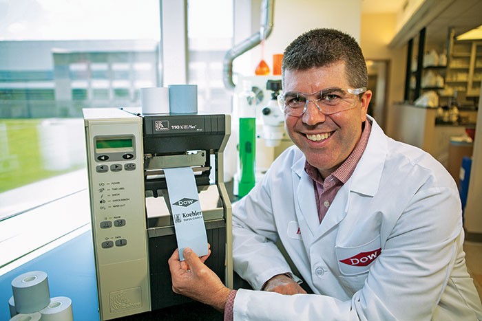 Dow R&D Manager Brian Einsla displays logos being printed on thermal paper.