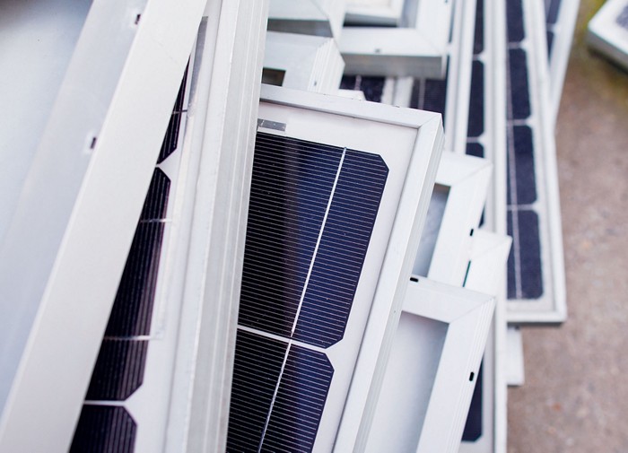 Image of old solar panels in a bin to be recycled.