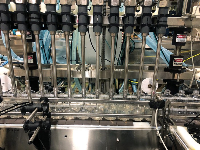 A photo of bottles being filled on a filling line.