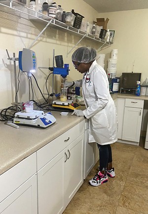 A photo of a woman in a formulation lab.