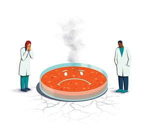 Two scientists stand devastated next to a red petri dish with a frown face, over cracked ground with smoke rising from it.