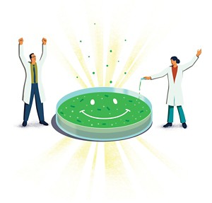 An illustration of two happy scientists standing next to a green petri dish with a smiley face on it.