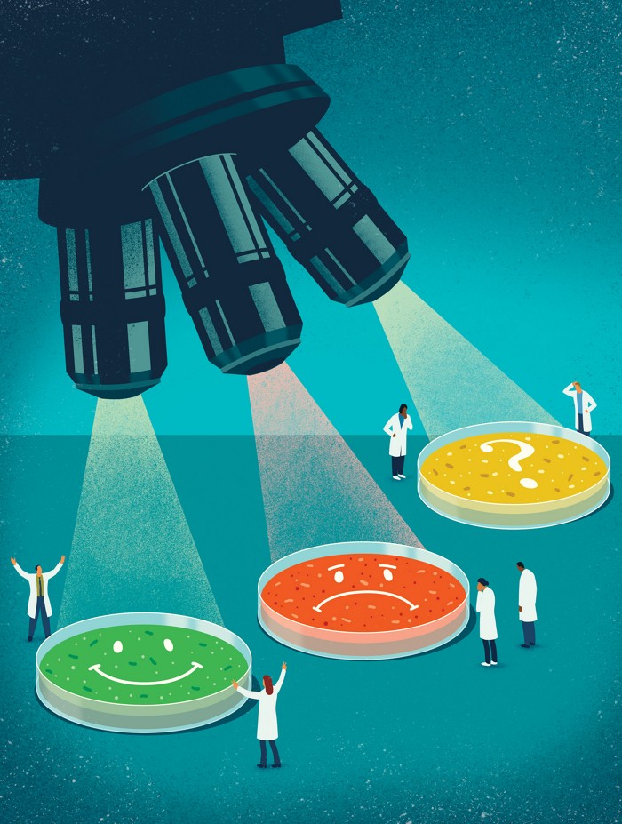 A conceptual illustration of a microscope with three lenses, shining on three petri dishes, colored green, yellow, or red. The green dish has a smiley face, the red a frown face, and the yellow a question mark.