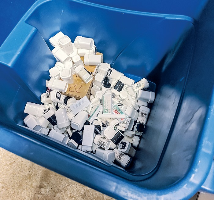 A recycling bin with cannabis packaging waste.