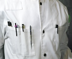Close-up of a white lab coat showing plenty of perfectly sized pockets to fit pens and tweezers.