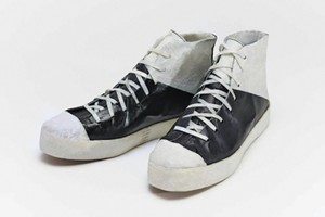 Black-and-white sneakers made out of a leather-like material.