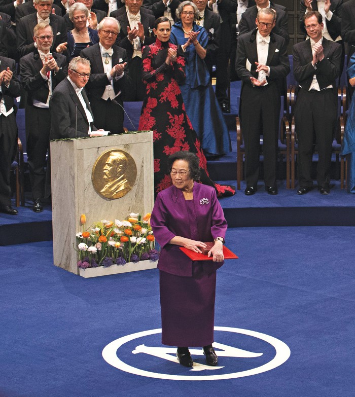 Tu Youyou leaves the stage after receiving her 2015 Nobel Prize in Physiology or Medicine at the cerenomy in Sweden.