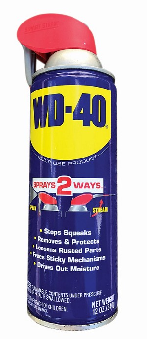 WD-40 on a table made from faded wood.