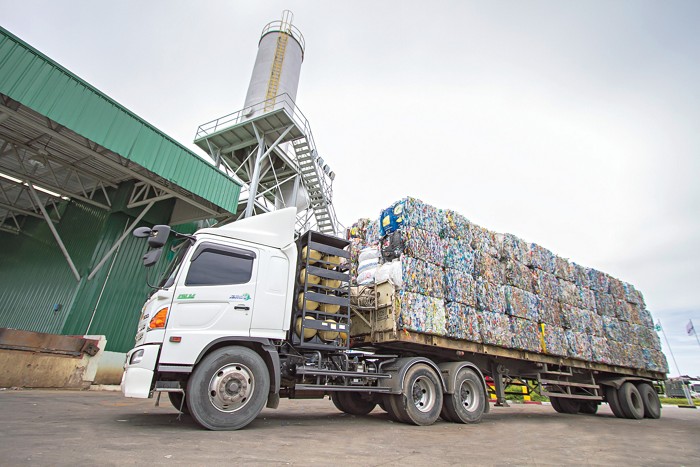 A truck carrying bales of crushed polyethylene terephthalate bottles, such as soda bottles, arrives at an Indorama Ventures recycling plant in Thailand.