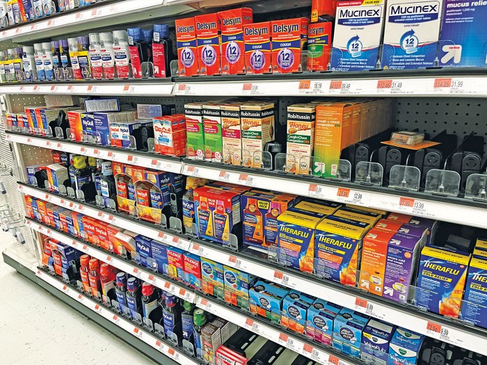 Store shelves full of cough and cold medications.