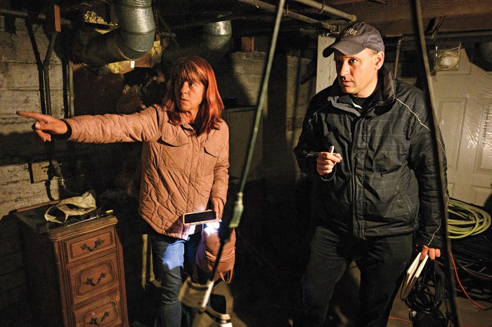 A man examines a basement.