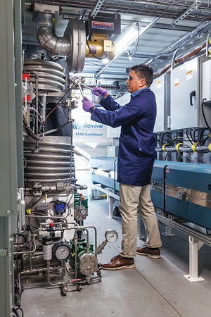 An engineer removes the heat exchanger feed tube in a supercritical water oxidation unit for destroying per- and polyfluoroalkyl substances.